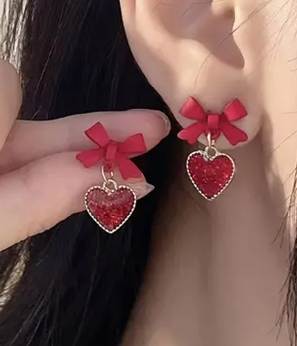 Bow and heart dangle earring