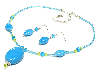 Pastel tone figurin and glass necklace and earring set