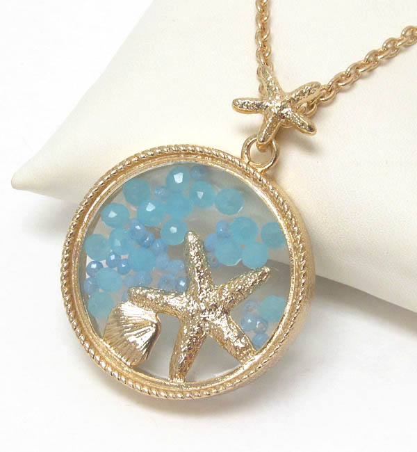 Starfish and floating bead in glass disk pendant necklace