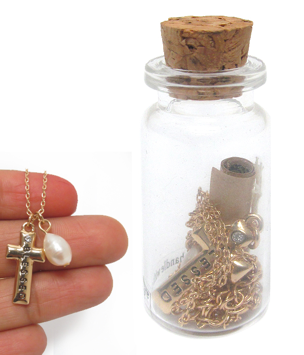 Cross necklace and message in glass bottle