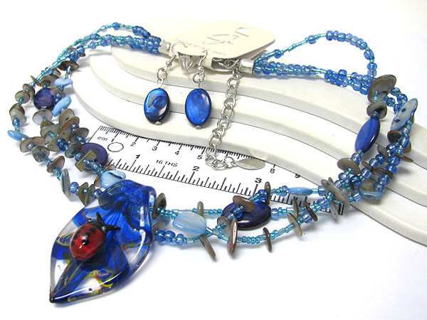 Multi seed beads and chip stone drop murano glass leaf with center ladybug necklace earring set