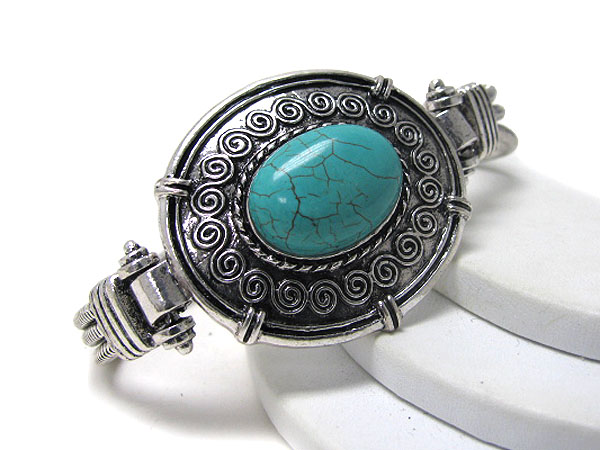 Turquoise center and metal casting bracelet