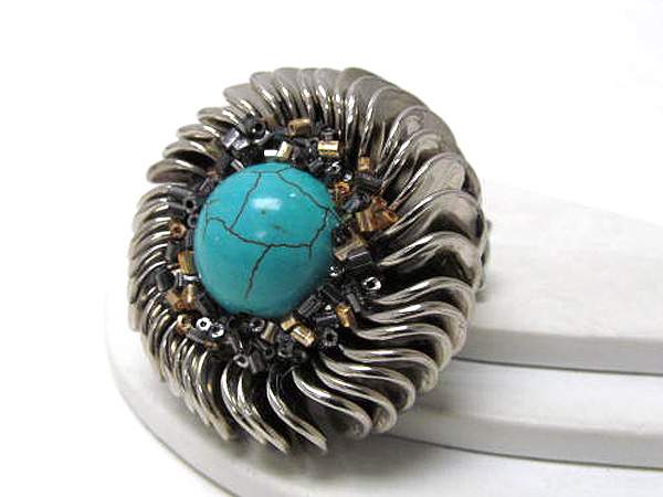 Multicasting multi layer and on center turqoise stone stretch ring