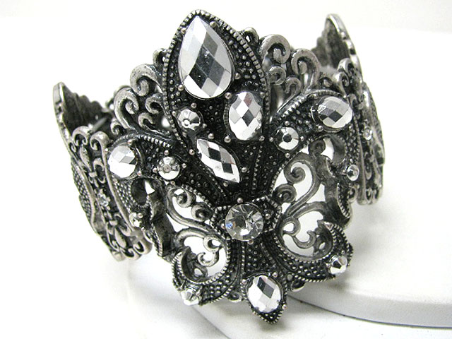 Crystal and metallic stone stud fleur de lis metal hinge bangle