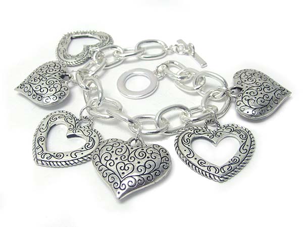 Metal textured multi heart caharm dangl;e toggle bracelet