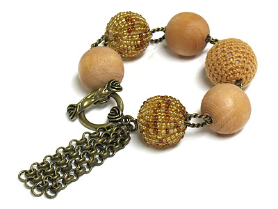 Woven ball and tasell drop bracelet