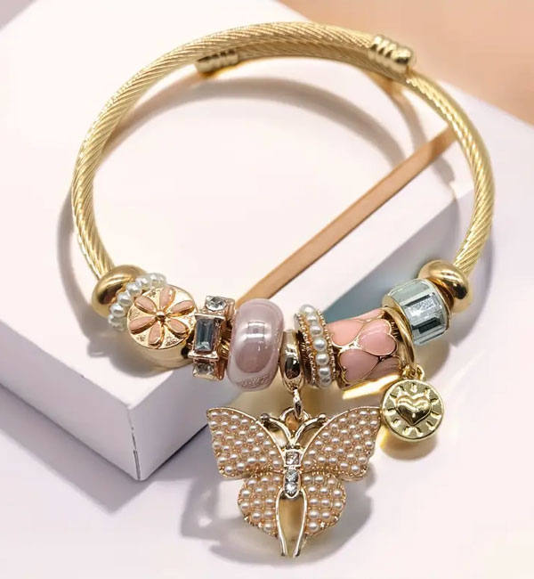 Elegant gold bracelet with pearls and butterfly charm