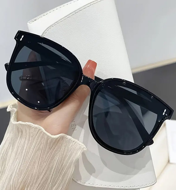 Sophisticated oversized black sunglasses with dark lenses and sleek design