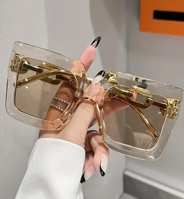 Stylish oversized square sunglasses with transparent frames and gold accents