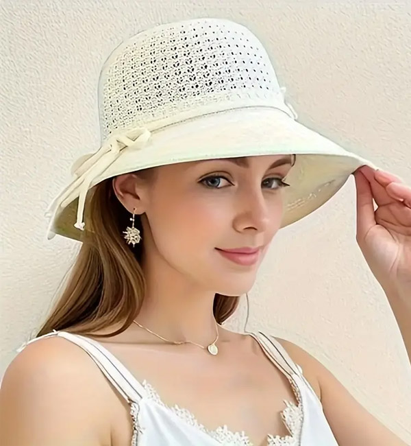 Elegant white sun hat with lace details and decorative bow