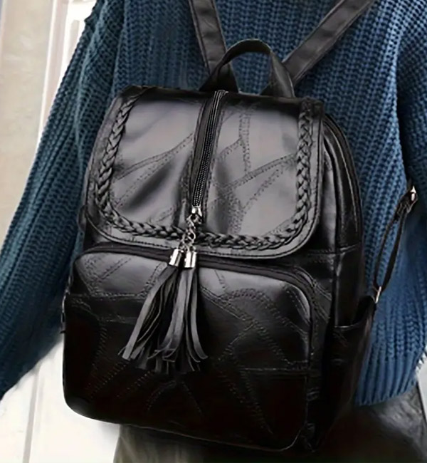 Black leather backpack with braided and tassel details