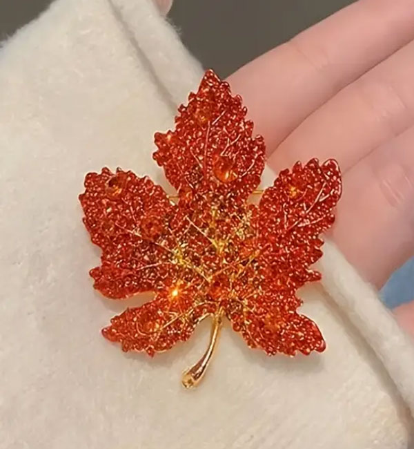 Sparkling red maple leaf brooch