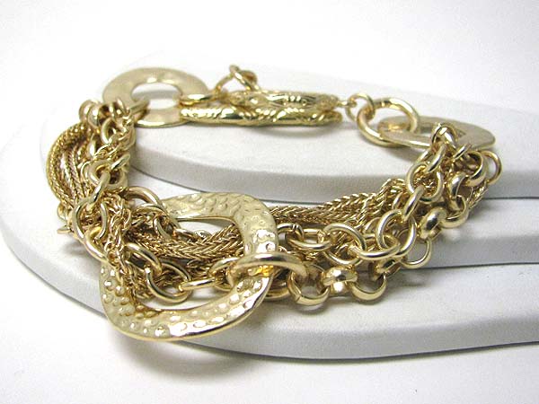 Architectural hammered metal donut and multi chain toggle bracelet