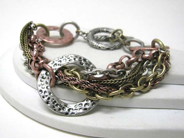 Architectural hammered metal donut and multi chain toggle bracelet