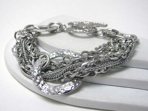 Architectural hammered metal donut and multi chain toggle bracelet