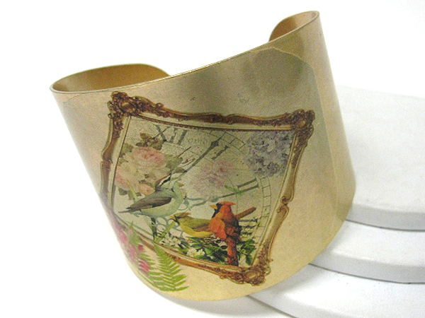 Antique style bird paint on a metal bracelet