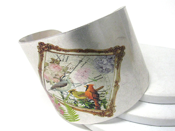 Antique style bird paint on a metal bracelet