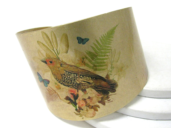 Antique style bird paint on a metal bracelet