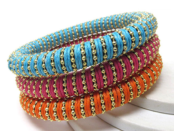 Multi row wood and small metal balls on fabric wrapped bangle set