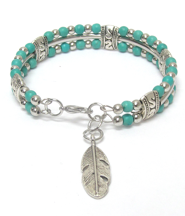 Feather charm and turquoise ball bracelet