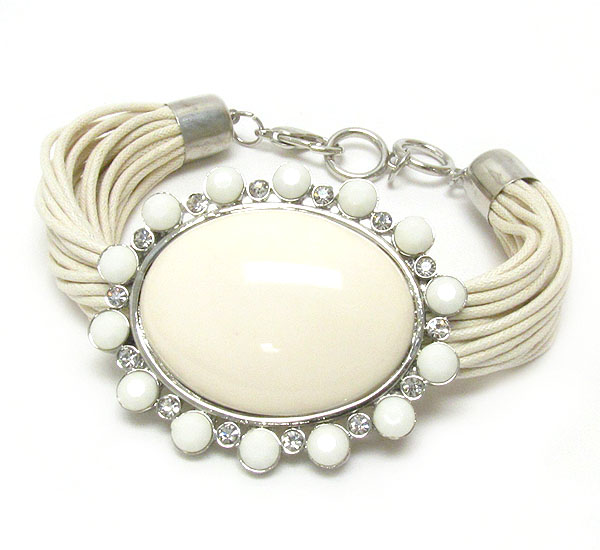 Crystal and puff oval acrylic pendant and multi cord bracelet