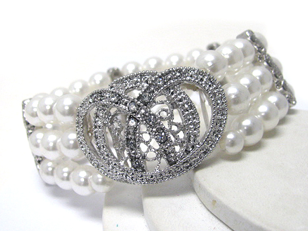 Crystal deco on pretzel metal casting and pearl chain stretch bracelet