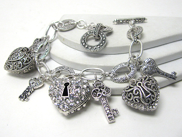 Crystal stud multi puff heart and key charm toggle bracelet