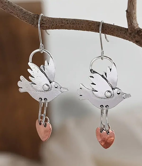 Flying bird carrying heart earring