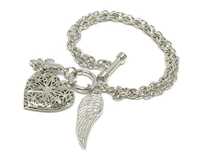 Metal filgree heart locket and charms toggle bracelet 