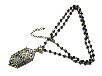 Filegree metal casting with crystal pendant and double beqds string necklace