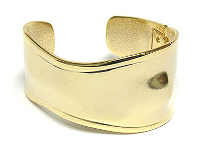 Waved shape gold tone metal cuff bangle