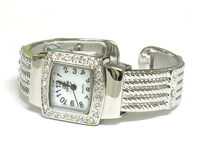 Crystal on face and metal band cuff watch