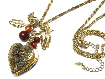 Filigree metal heart locket and leaves and ball necklace