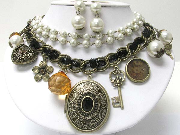 Metal filigree oval locket and mixed antique metal charm dangle pearl and multi chain necklace earring set