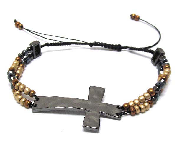 Hammered metal cross with seed beads on braided yarn friendship bracelet