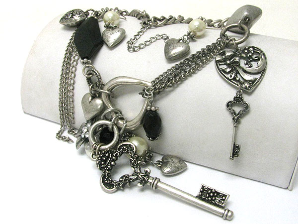 Textured metal key and mixed charm dangle necklace earring set