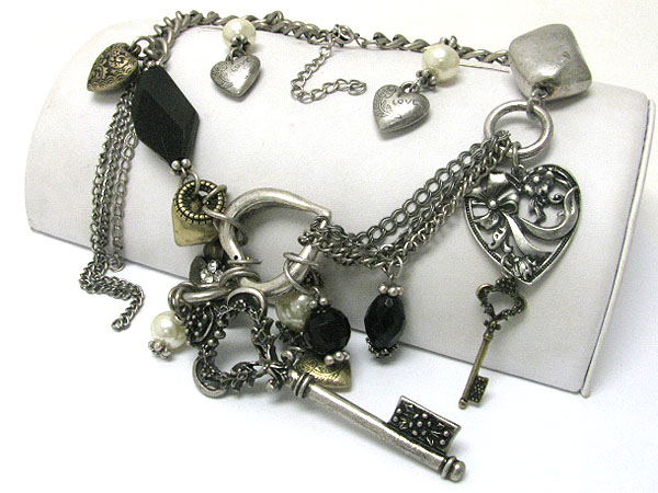 Textured metal key and mixed charm dangle necklace earring set